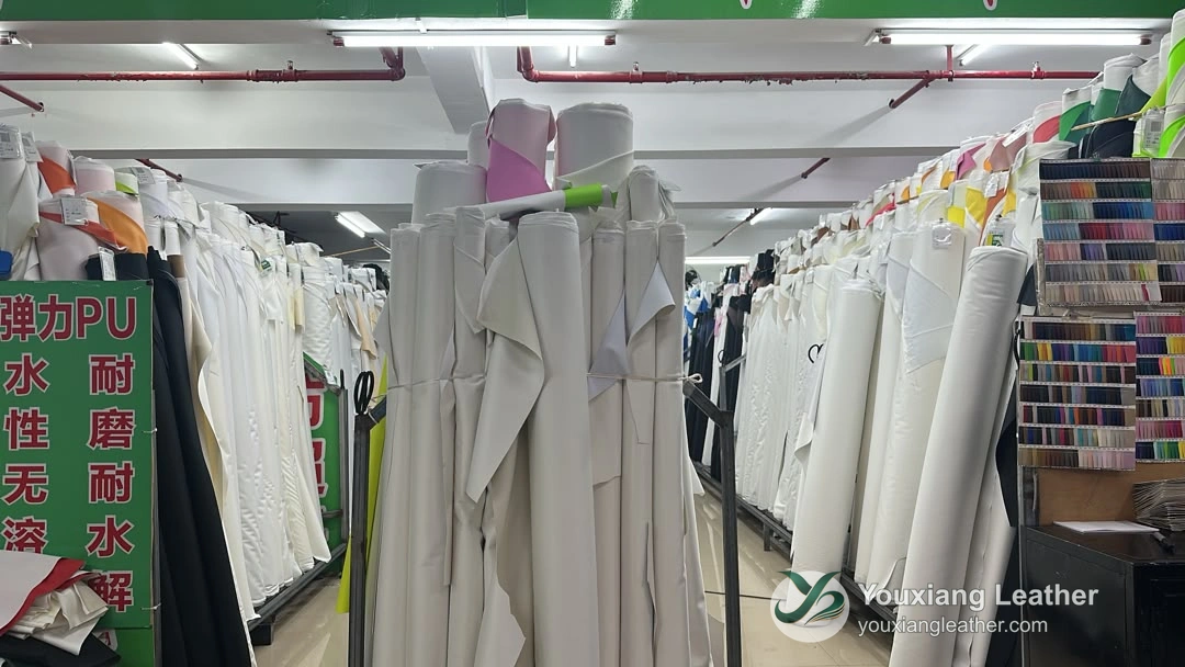 Material rolls and color cards at our Jinjiang shop.