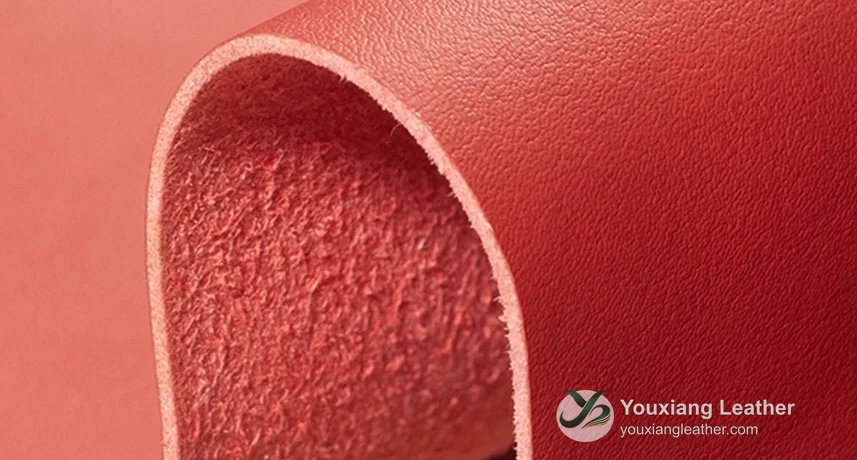 Red PU microfiber sample showing the grain, exposed backing and cut edge